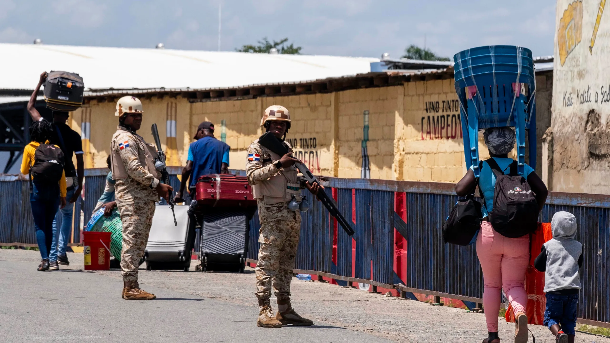 A Dominican soldier standing guard at a closed border crossing