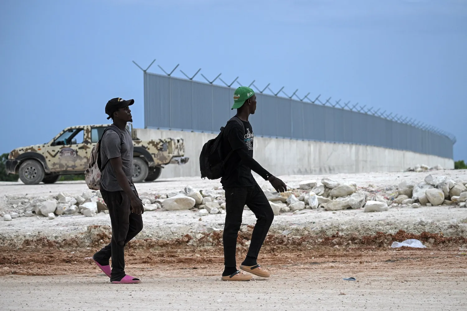 Soldiers beside the border wall between Haiti and the Dominican Republic