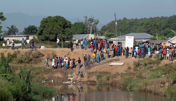 Haitians gathered at a river crossing during deportation operations