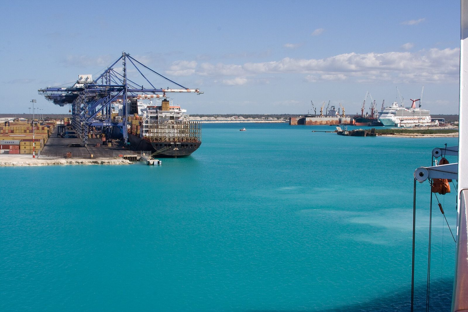 Container ship at Freeport Harbour with cranes and the Grand Bahama Shipyard in the background