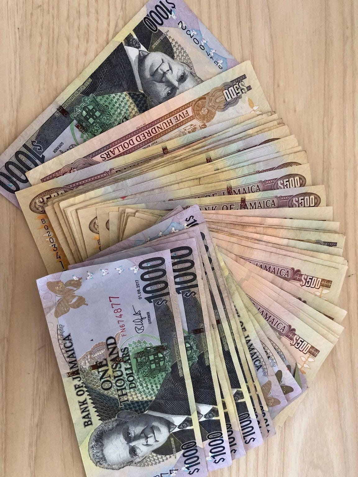 If we offered you $1 million Jamaican dollars to parasail off the rooftop of Atlanta would you take it? 

Or would you rather we pay you $50 thousand Bahamian dollars?